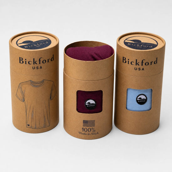 Bickford USA product packaging featuring three kraft paper tee tubes, including burgundy and light blue tees visible through the front windows with Bickford logo patches.