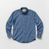 Bickford USA Denim Field Shirt in medium wash chambray denim, flat lay front view, featuring a button-down collar, single chest pocket with button flap, cream buttons down the placket, and button cuffs, against a light gray background.