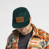 Man wearing Bickford USA Field Patch 5-Panel Wool Cap in green with flannel shirt