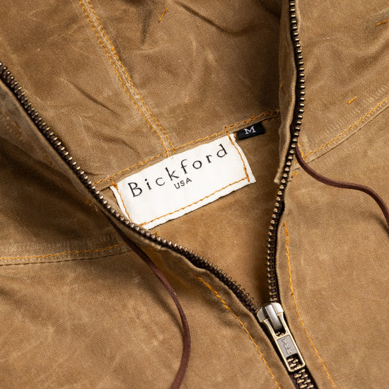 Close-up of the Bickford USA Anorak Sailcloth Jacket collar, showing the woven Bickford USA label, brass YKK zipper, and contrast topstitching on waxed cotton.