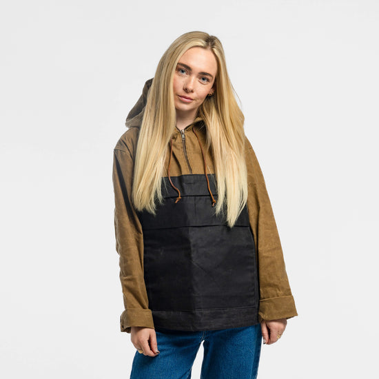 Woman wearing the Bickford USA Anorak Sailcloth Jacket in tan and black waxed cotton, front view, styled with blue jeans.