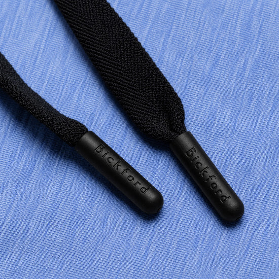 Close-up of Bickford engraved black drawstring tips on Blue Bird athletic jogger fabric