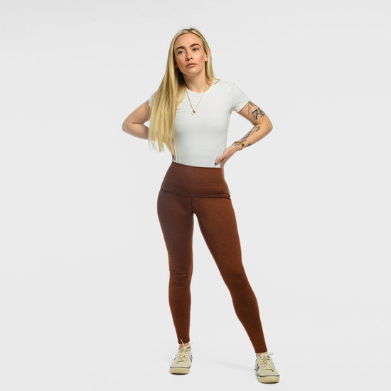Woman wearing the Bickford USA Athletic Leggings in rust, high-waisted, styled with a white tee and sneakers.