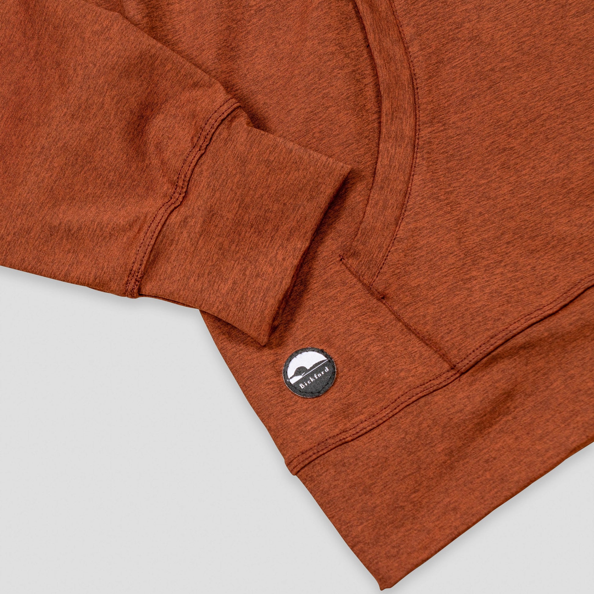 Detail of kangaroo pocket and Bickford logo patch on Rust Athletic Quarter Zip Hoodie