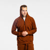 Man wearing Bickford Athletic Quarter Zip Hoodie with hood up in Rust, three-quarter view
