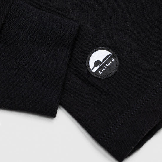 Detail of cuff and Bickford logo patch on Black Everyday Long Sleeve Tee