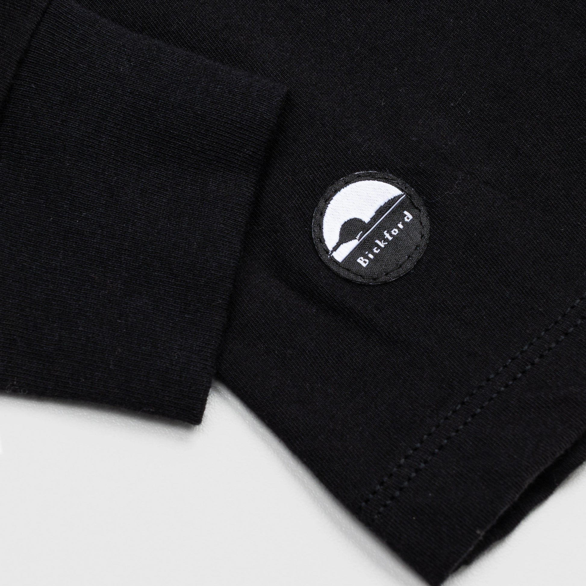 Detail of cuff and Bickford logo patch on Black Everyday Long Sleeve Tee