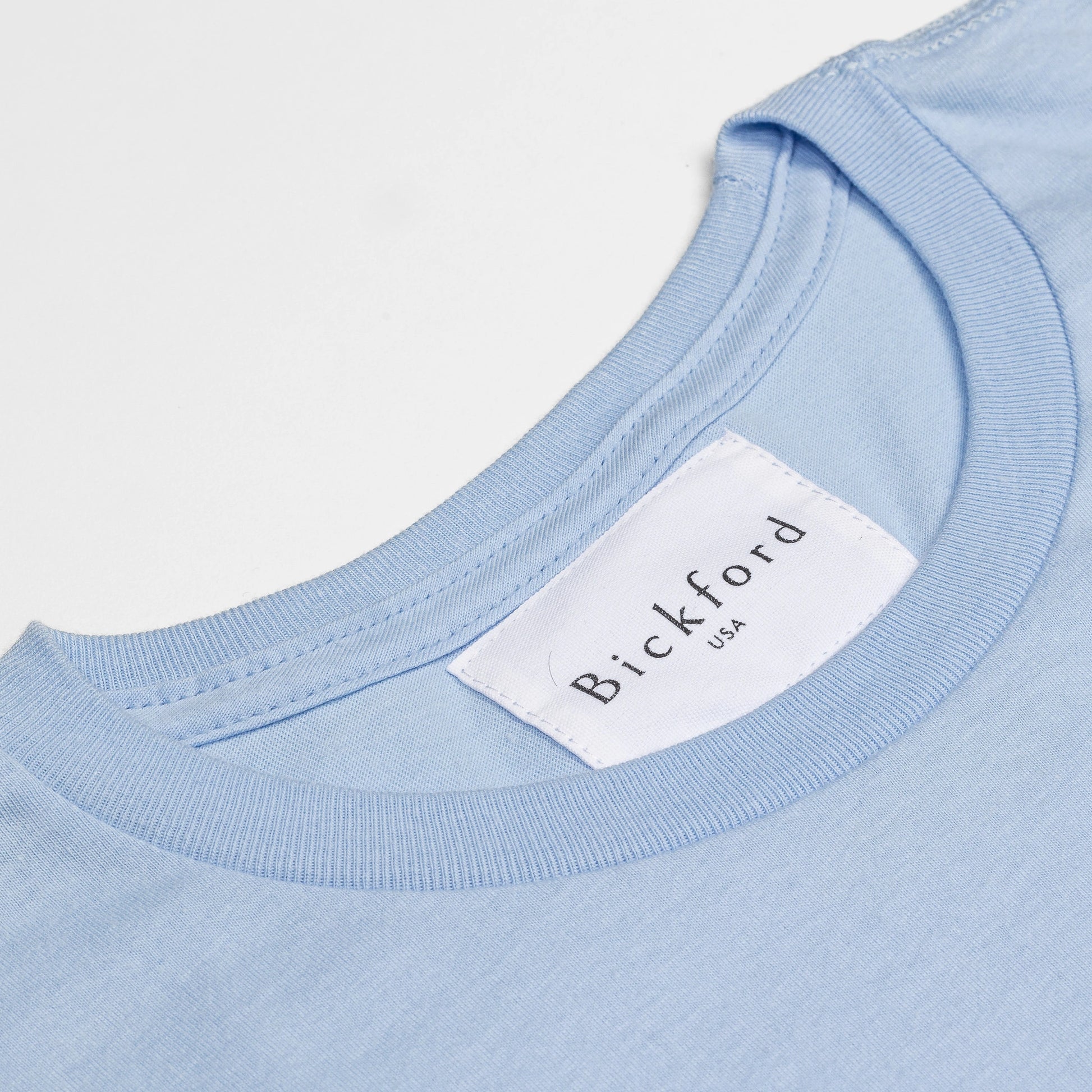 Close-up of Bickford USA woven neck label on Sky Blue Everyday Tee