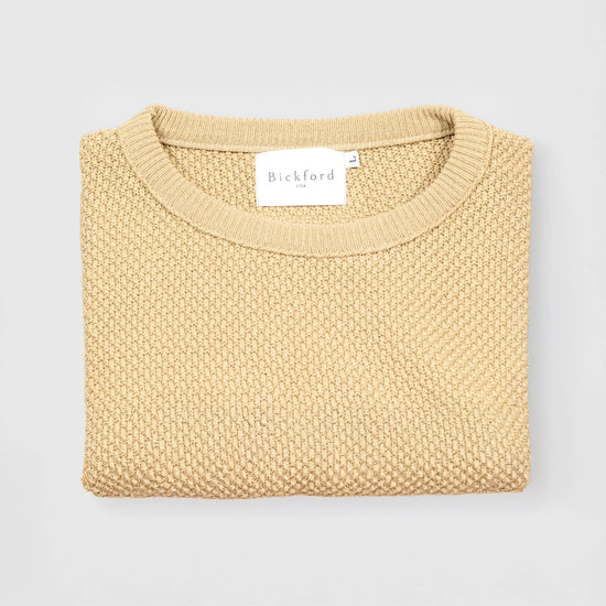 Bickford USA Fisherman Crewneck sweater in cream, neatly folded and photographed from above, with the Bickford USA label visible at the center of the neckline.