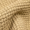 Close-up detail of the cream Fisherman Crewneck showing the folded hem and cuff area, highlighting the contrast between the seed stitch body fabric and the ribbed knit trim.