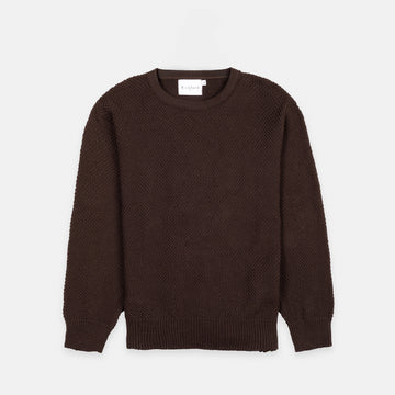 Bickford USA Fisherman sweater in dark brown, laid flat on a light gray background, showing the full front with seed stitch knit texture and ribbed crew neck, cuffs, and hem.
