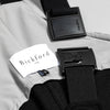 Close-up detail of a Bickford USA label and Fidlock magnetic buckle hardware on the black fleece overall bib, showing the two-piece snap closure system.