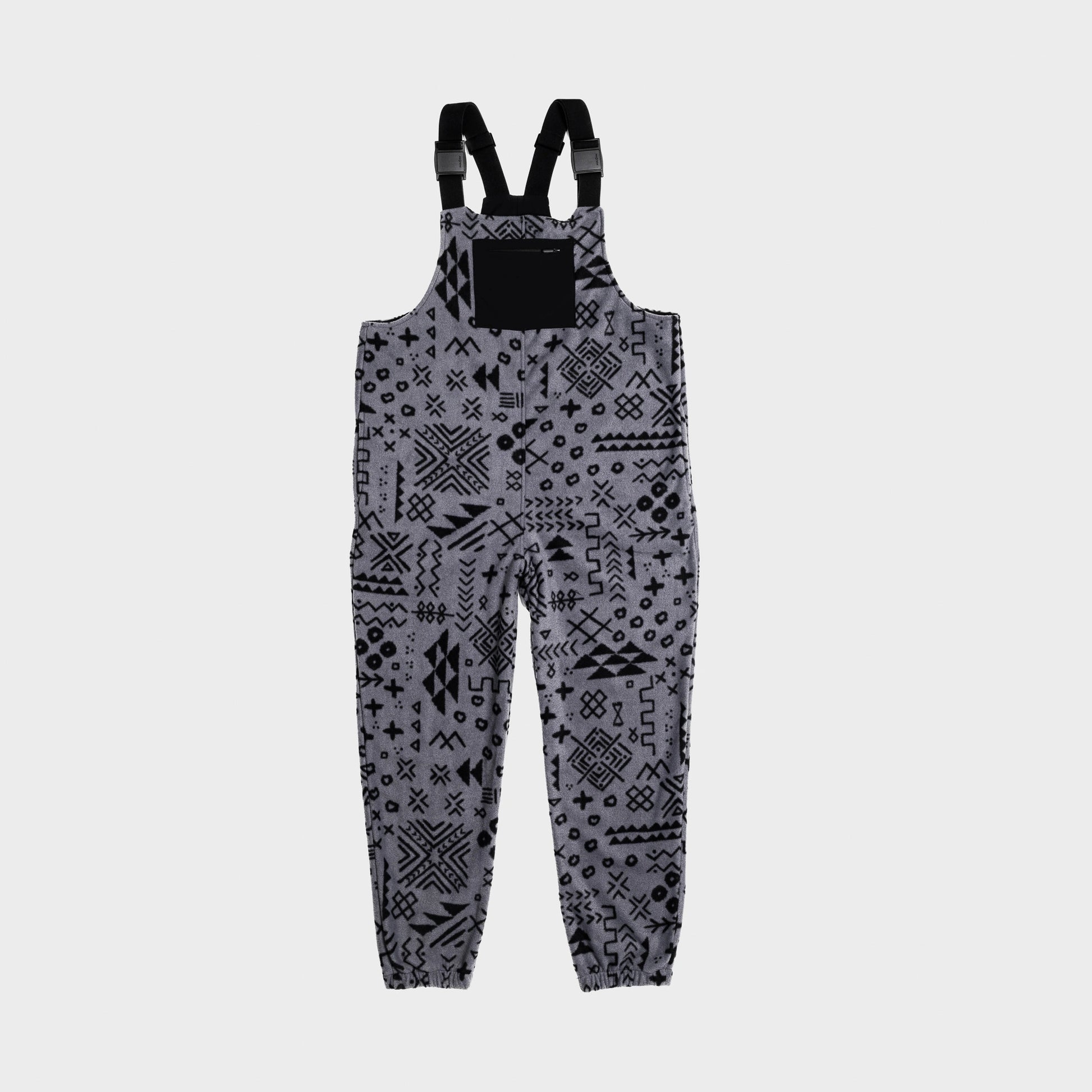 Bickford USA fleece overall bib in the Boulder colorway — a gray base with an allover black geometric and tribal print — front view with black chest pocket and Fidlock buckles, against a light gray background.