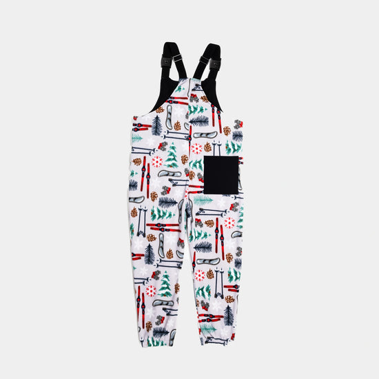 Bickford USA fleece overall bib in the Sugarbush colorway, back view, showing the black square back pocket, elastic ankle cuffs, and the full winter ski resort print pattern, against a light gray background.