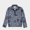 Bickford USA quarter-snap fleece pullover in the Boulder colorway — a gray base with an allover black geometric and tribal print — flat lay front view, featuring a black grosgrain placket with silver snap buttons and matching trim, against a light gray background.