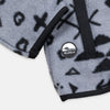 Close-up detail of the hem and side pocket area of the Bickford USA Boulder colorway quarter-snap pullover, showing the black grosgrain trim and a circular woven Bickford logo patch on the lower left hem.