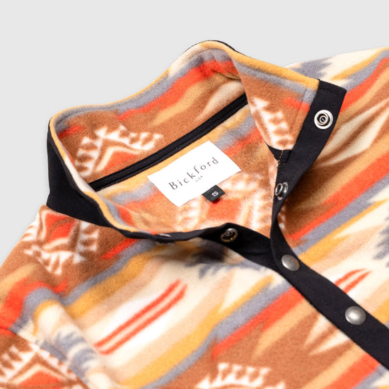 Close-up detail of the open collar and snap placket on the Bickford USA Heritage Trail colorway quarter-snap pullover, showing the black grosgrain trim, silver snap buttons, and Bickford USA size S label inside the collar.