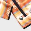 Close-up detail of the hem and side pocket area of the Bickford USA Heritage Trail colorway quarter-snap pullover, showing the black grosgrain trim and a circular woven Bickford logo patch on the lower left hem.