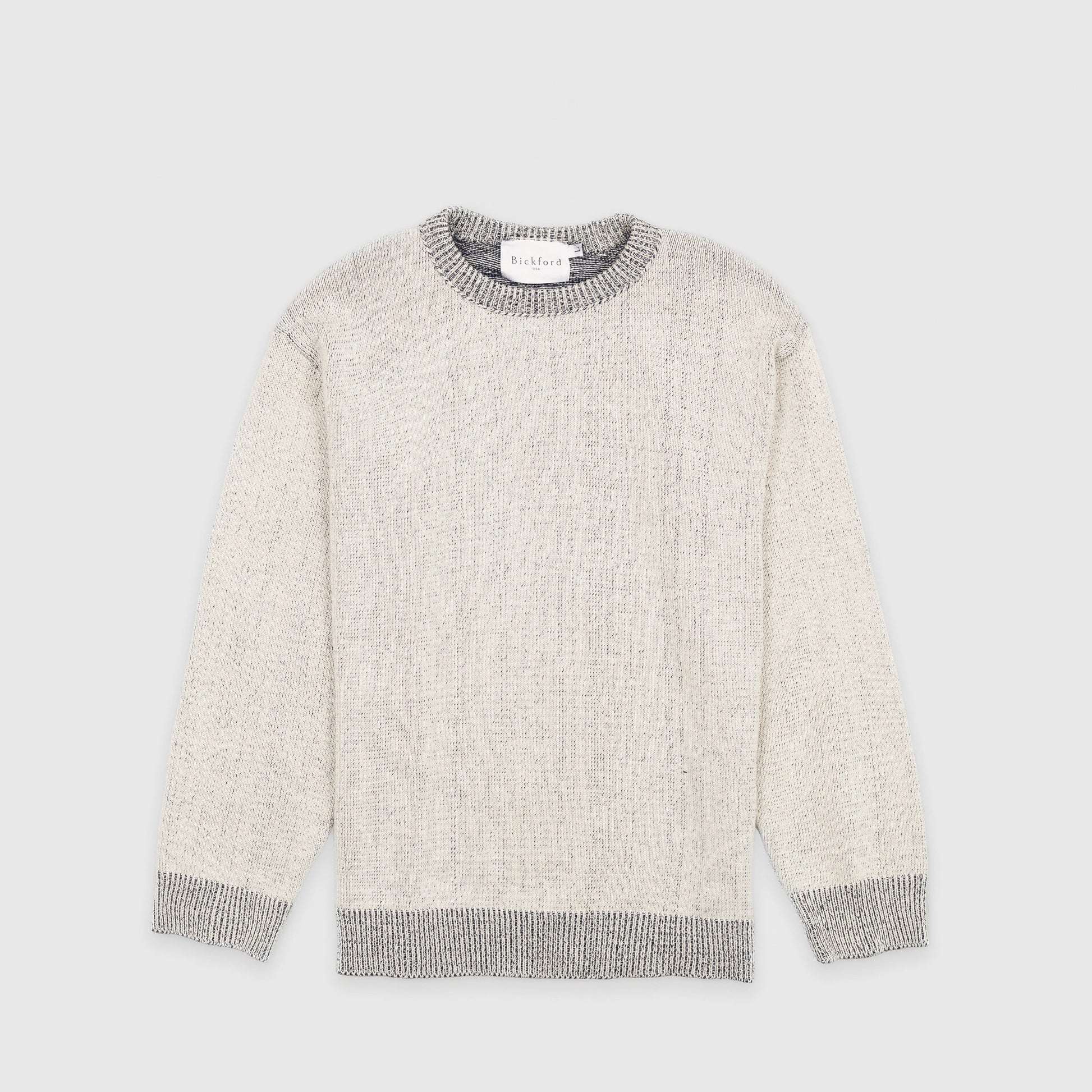 Bickford USA The 1926 Sweater in natural and grey, laid flat on a light gray background, showing the full front with a marled knit body and contrasting grey ribbed crew neck, cuffs, and hem.