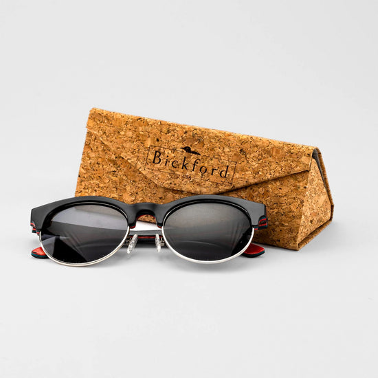 Bickford USA Timberline Half-Frame Sunglasses in midnight black beside the branded cork carrying case.
