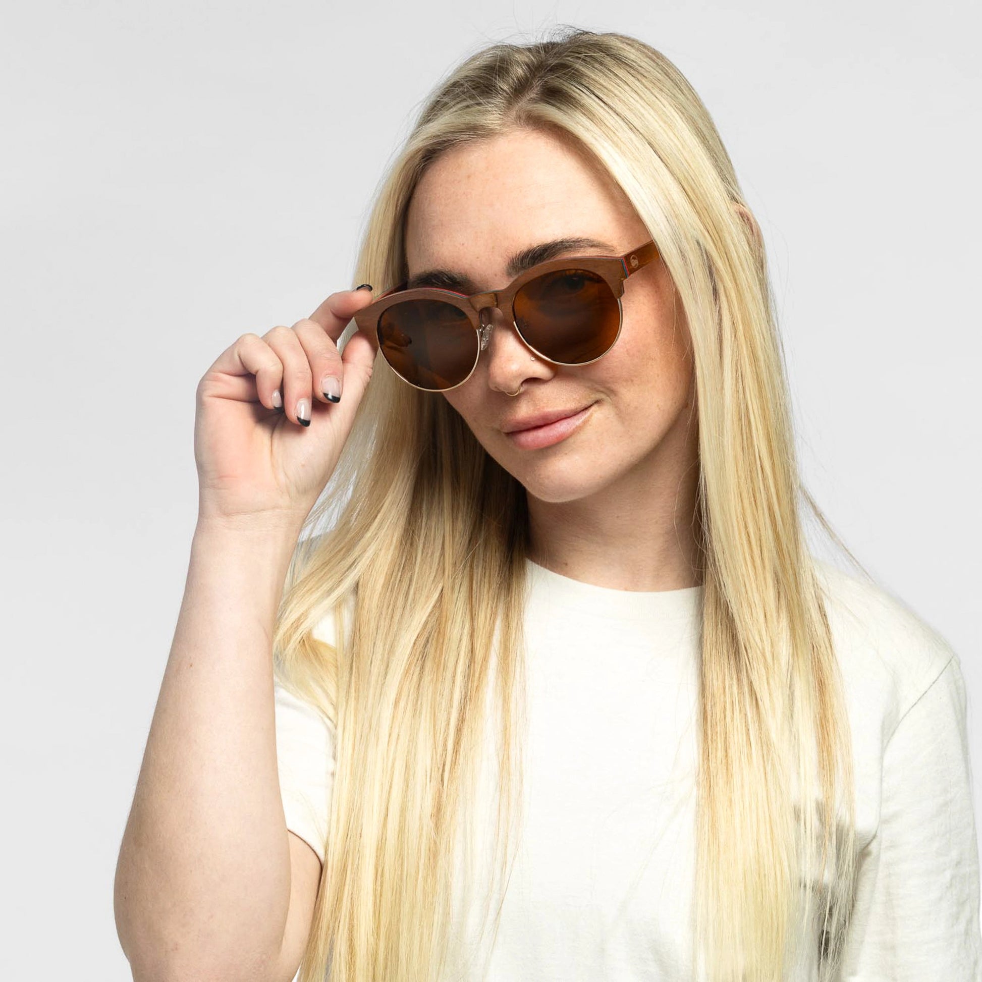 Woman wearing the Bickford USA Timberline Half-Frame Sunglasses in walnut wood with brown lenses.