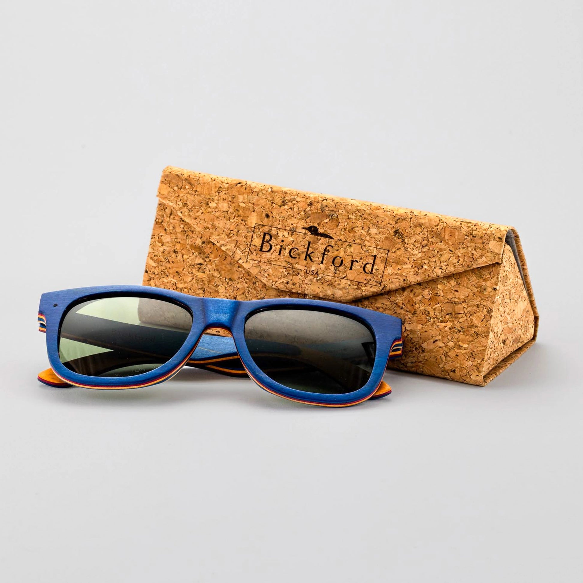 Bickford USA Timberline Full-Frame Sunglasses in deep blue wood beside the branded cork carrying case.