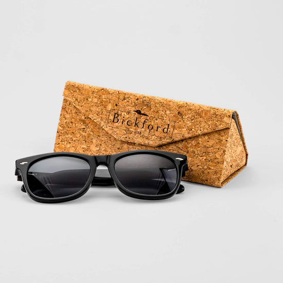 Bickford USA Timberline Full-Frame Sunglasses in midnight black beside the branded cork carrying case.