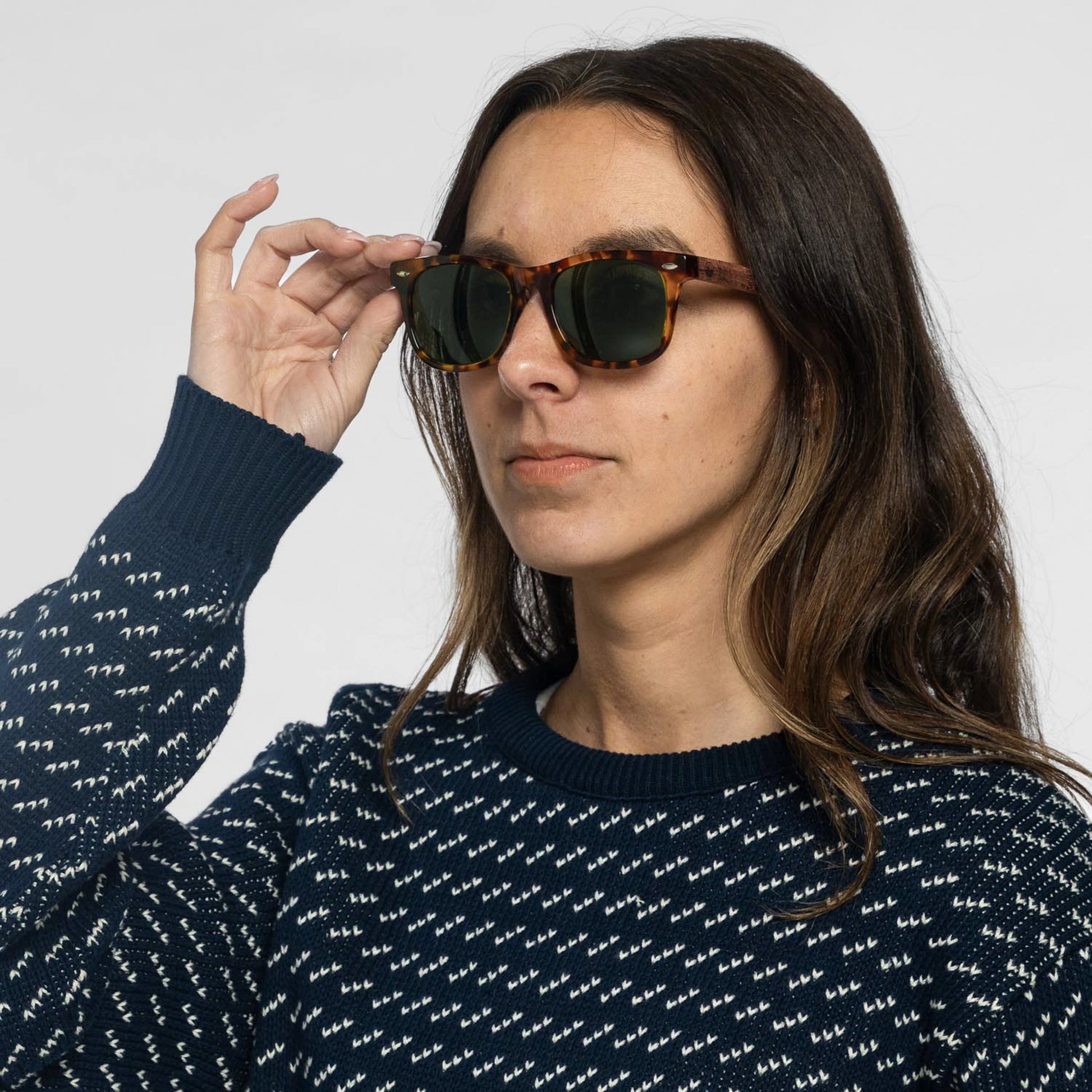 Woman wearing the Bickford USA Timberline Full-Frame Sunglasses in tortoise with green lenses, styled with a navy sweater.