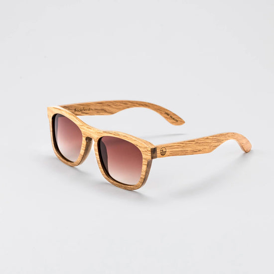 Bickford USA Timberline Full-Frame Sunglasses in natural zebrano wood, angled side view showing the grained wood frame and engraved Bickford logo.