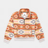 Bickford USA Women's Cropped Quarter-Zip fleece pullover in the Heritage Trail colorway, laid flat on a light gray background, featuring an all-over southwestern-style print with diamond and geometric motifs in orange, brown, red, grey, cream, and gold, with a wide fold-over collar, brass quarter-zip closure, front kangaroo pocket, and contrasting cream ribbed hem and cuffs.