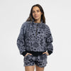 Woman wearing the Bickford USA boulder women's fleece shorts paired with a paired cropped quarter zipped fleece, hands in pockets against a white background.