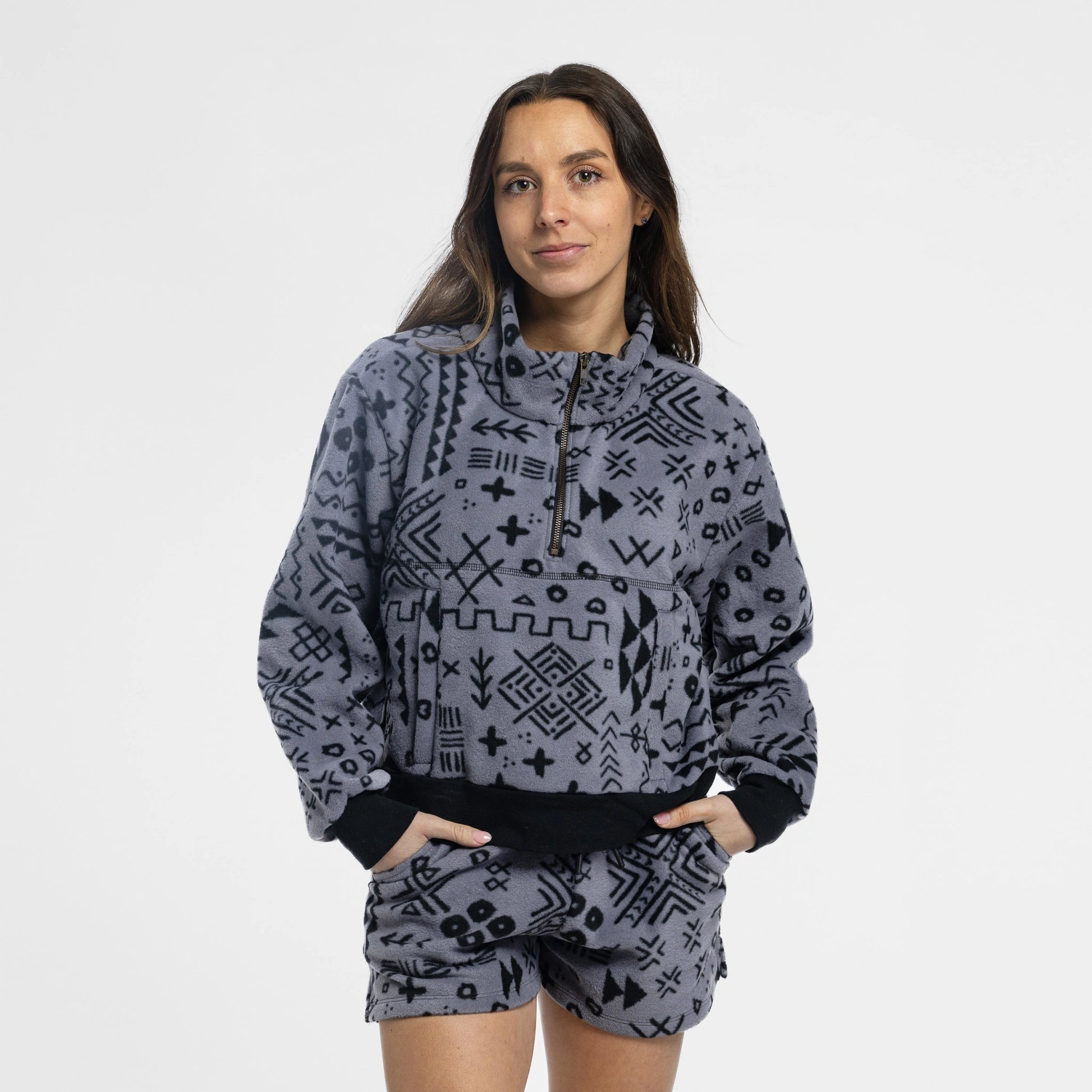 Woman wearing the Bickford USA boulder women's fleece shorts paired with a paired cropped quarter zipped fleece, hands in pockets against a white background.