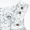 Close-up detail of the Snowflake Youth Overalls showing the adjustable shoulder straps with gunmetal snap closures against the grey and white ornate medallion print.