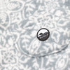 Close-up of the chest bib pocket on the Snowflake Youth Overalls showing the circular woven Bickford mountain logo patch centered on the pocket against the grey and white snowflake medallion pattern.