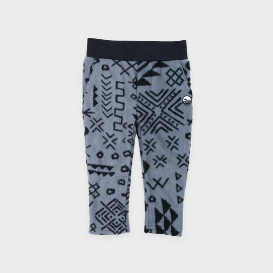 Bickford USA Youth fleece pants in the Boulder colorway, laid flat on a light gray background, featuring an all-over black geometric tribal print on a grey background, with a wide black elastic waistband, side hand pockets, and circular Bickford logo patch on the hip.