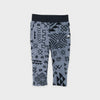 Bickford USA Youth fleece pants in the Boulder colorway, laid flat on a light gray background, featuring an all-over black geometric tribal print on a grey background, with a wide black elastic waistband, side hand pockets, and circular Bickford logo patch on the hip.