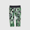 Bickford USA Youth fleece pants in the Eastern Pine colorway, laid flat on a light gray background, featuring an all-over print of layered pine trees in shades of green, black, and cream with a moon motif, with a wide black elastic waistband, side hand pockets, and circular Bickford logo patch on the hip.