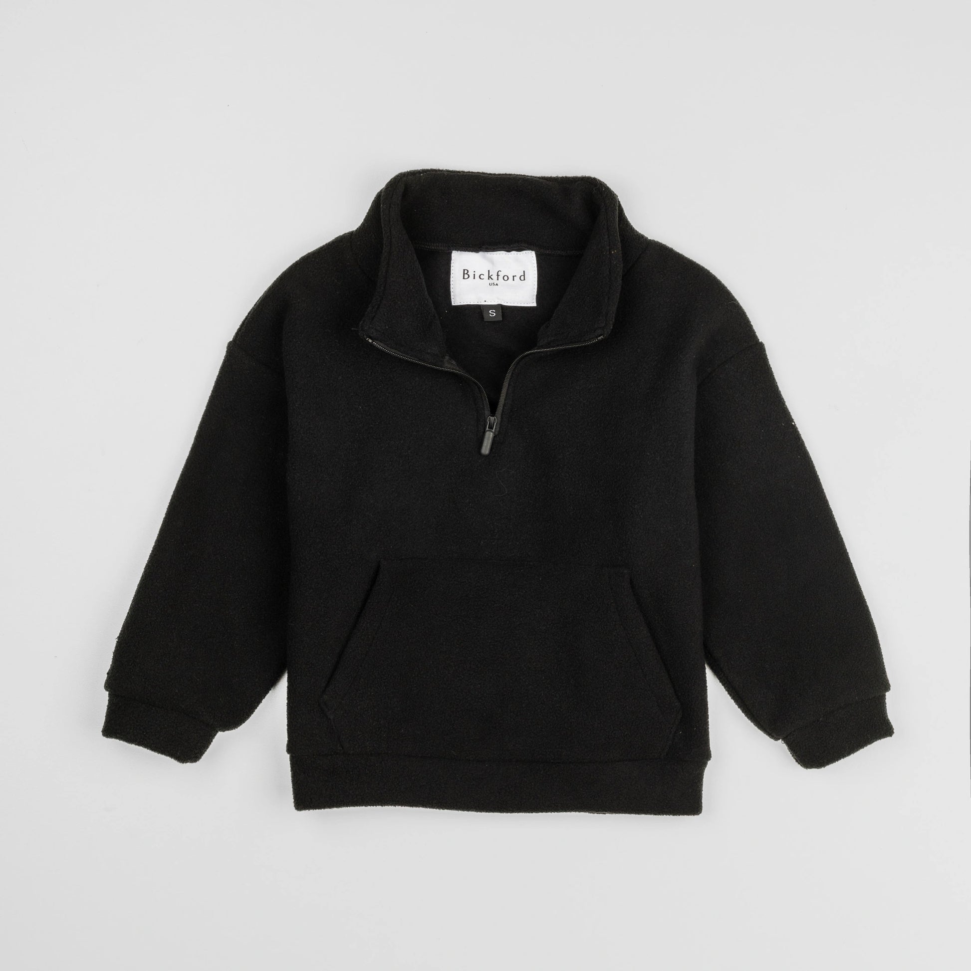 Bickford USA Youth Quarter-Zip fleece pullover in solid black, laid flat on a light gray background, showing the full front with a funnel collar, quarter-zip closure, and front kangaroo pocket.