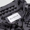 Close-up detail of the Boulder Youth Quarter-Zip showing the open funnel collar with the Bickford USA label and size tag visible, revealing the geometric tribal print on the inner collar and the black zipper.