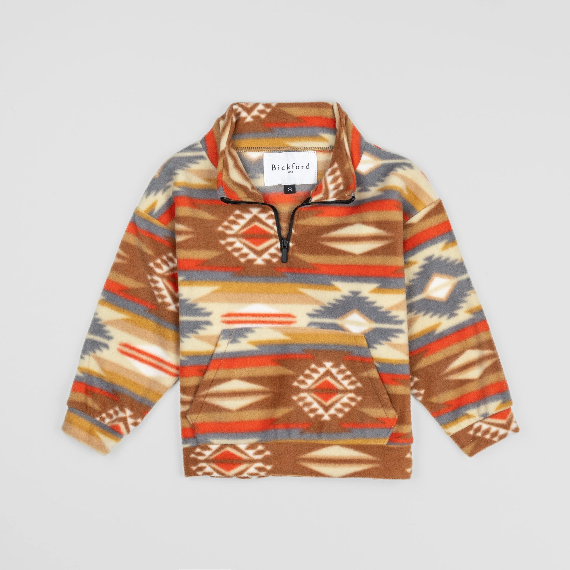Bickford USA Youth Quarter-Zip fleece pullover in the Heritage Trail colorway, laid flat on a light gray background, featuring an all-over southwestern-style print with diamond and geometric motifs in brown, orange, red, grey, cream, and gold, with a funnel collar, quarter-zip closure, and front kangaroo pocket.