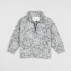 Bickford USA Youth Quarter-Zip fleece pullover in the Snowflake colorway, laid flat on a light gray background, featuring an all-over ornate snowflake and medallion print in grey and white, with a funnel collar, quarter-zip closure, and front kangaroo pocket.