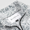 Close-up detail of the Snowflake Youth Quarter-Zip showing the open funnel collar with the Bickford USA label and size tag visible, with the grey and white medallion print visible on the inner collar and the black zipper.