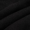 Close-up macro shot of solid black fleece fabric showing the dense, soft pile texture with subtle surface variation.